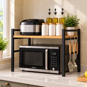 Home – Real Designs Countertop oven rack and microwave stand with black metal frame and wood-finish shelf, with hooks for hanging kitchen utensils